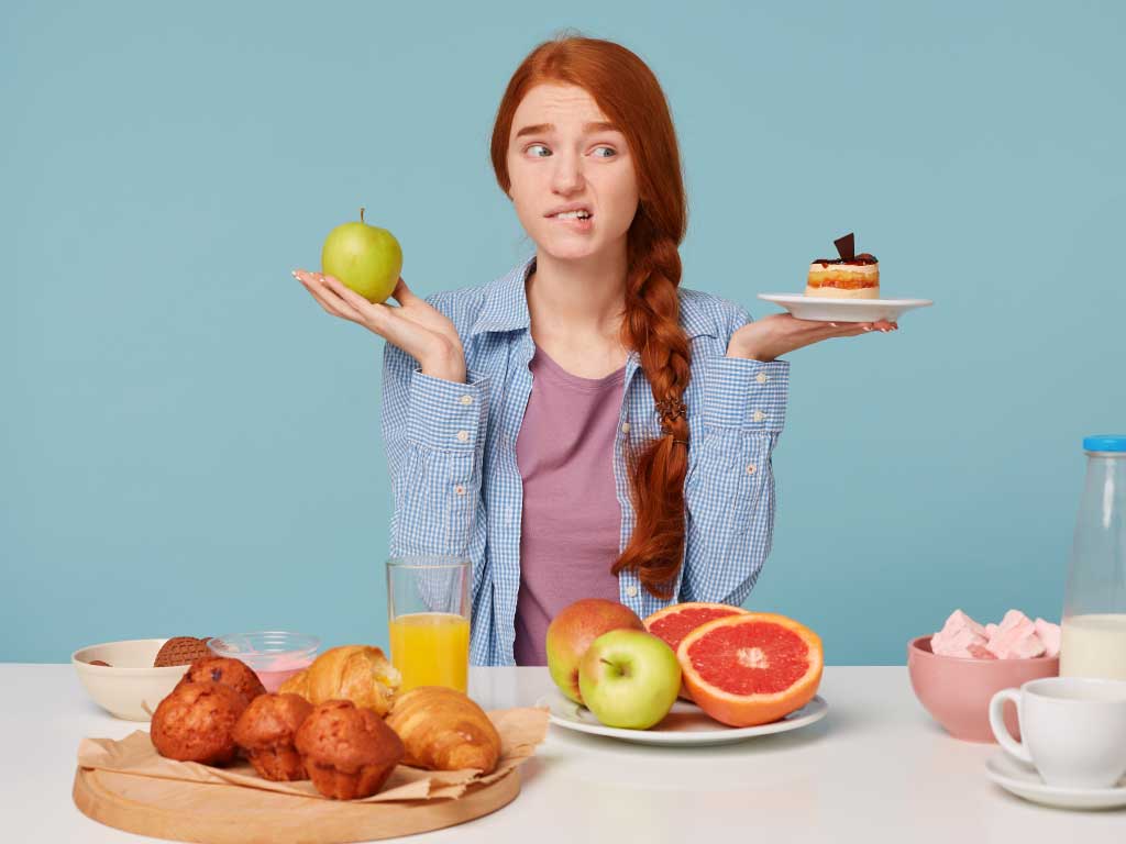 girl undecided healthy apple or cake